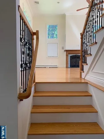 a view of entryway and hall with wooden floor