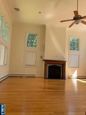 a view of an empty room with a fireplace and a window