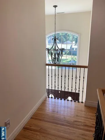 a view of room with wooden floor