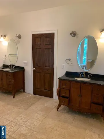 a room with a mirror and dresser