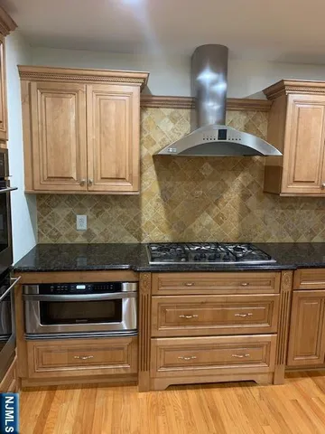 a kitchen with granite countertop a stove and a sink