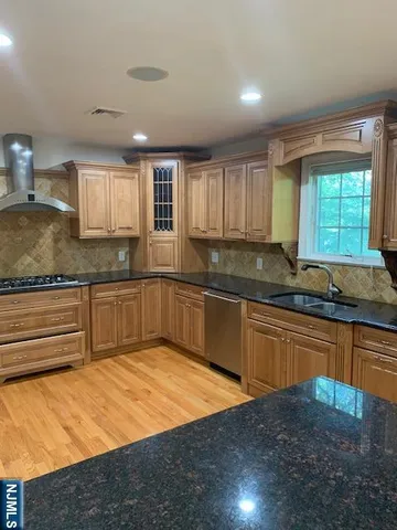 a kitchen with granite countertop a sink and a stove