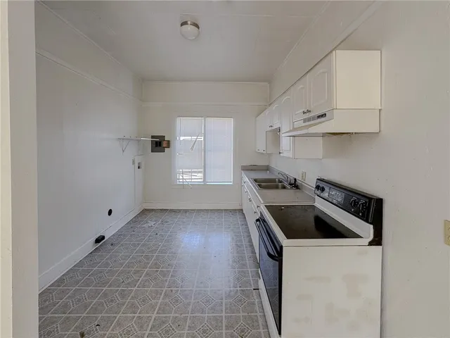 a kitchen that has a sink and a stove
