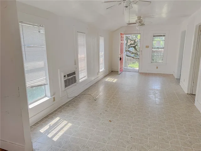 an empty room with windows and closet