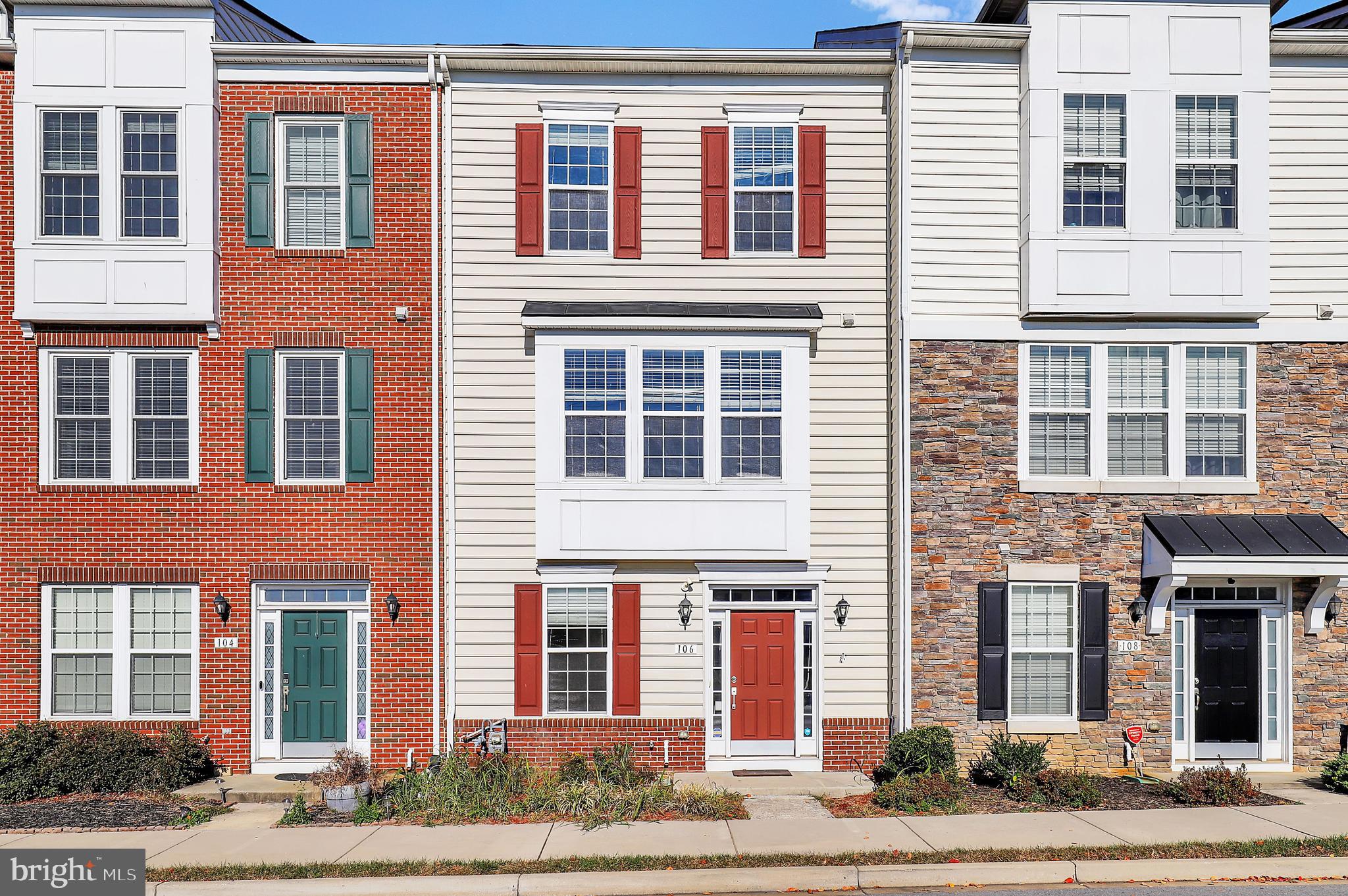 a front view of a house with a garden and windows