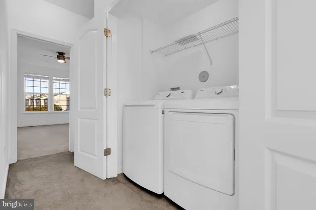 a utility room with cabinets washer and dryer