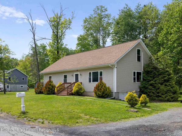 a front view of house with yard and green space