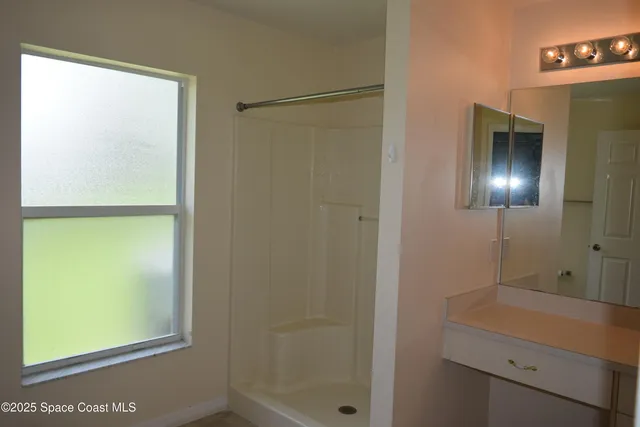 a bathroom with a shower and a sink