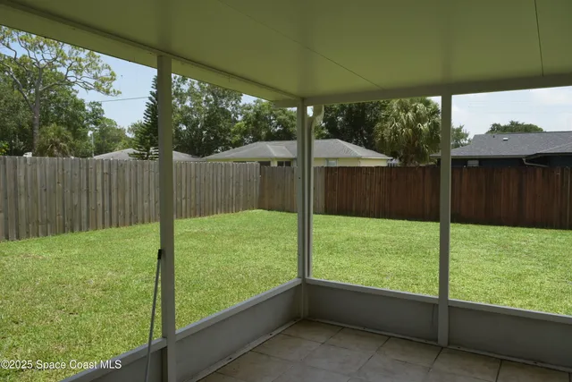 a view of backyard with green space and seating