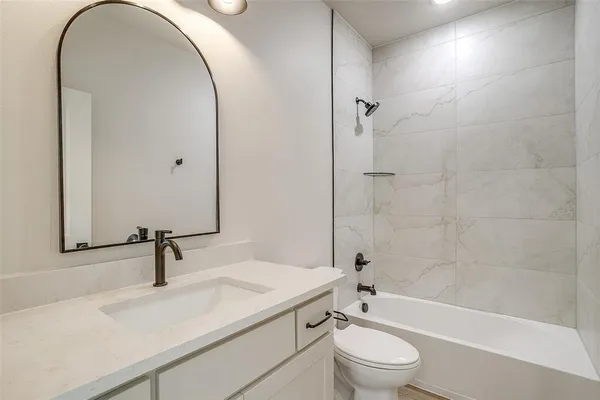 a bathroom with a double vanity sink toilet and shower