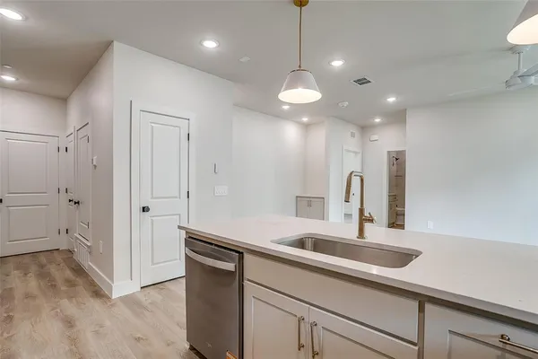 a view of a kitchen with a sink and dishwasher