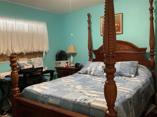 a bedroom with bed and window