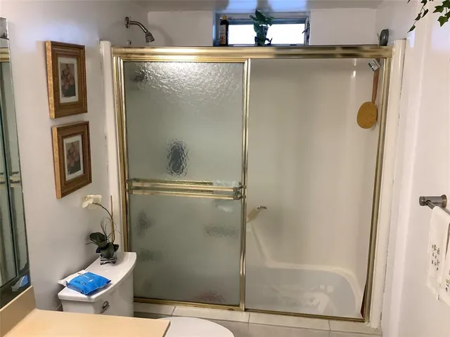 a bathroom with a shower and mirror