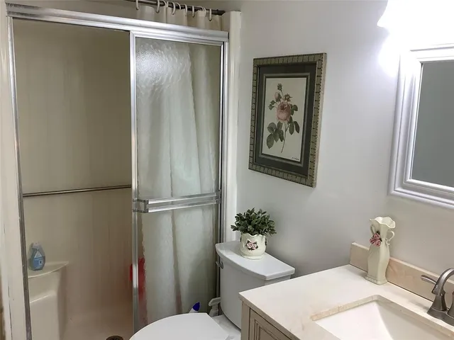 a bathroom with a toilet a sink and tub