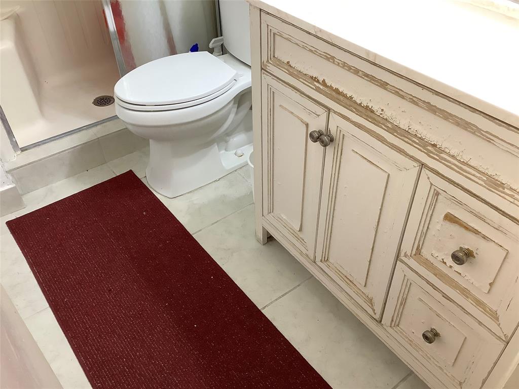 2300 Northeast 1st Lane, Unit 107 Boynton Beach, FL 33435 - Photo 20 of 26 a bathroom with a toilet and a shower