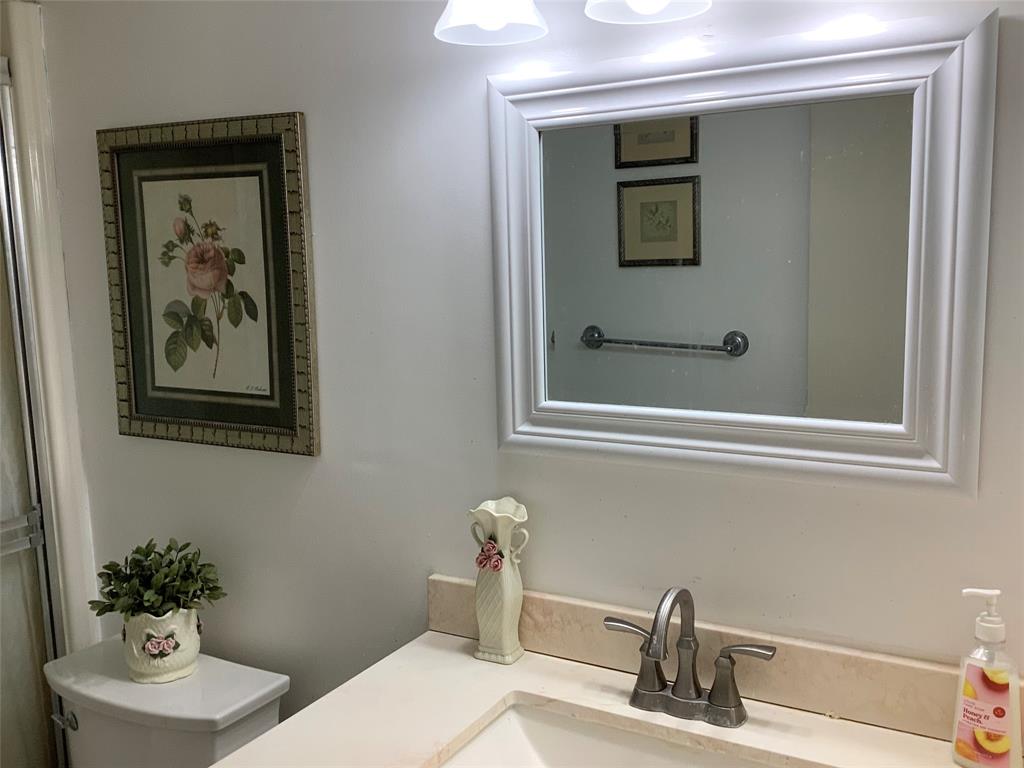 2300 Northeast 1st Lane, Unit 107 Boynton Beach, FL 33435 - Photo 21 of 26 a bathroom with a sink and a mirror