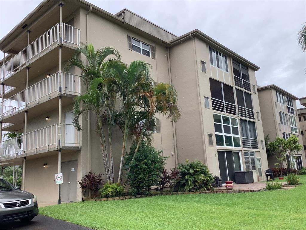 2300 Northeast 1st Lane, Unit 107 Boynton Beach, FL 33435 - Photo 23 of 26 a front view of a house with garden