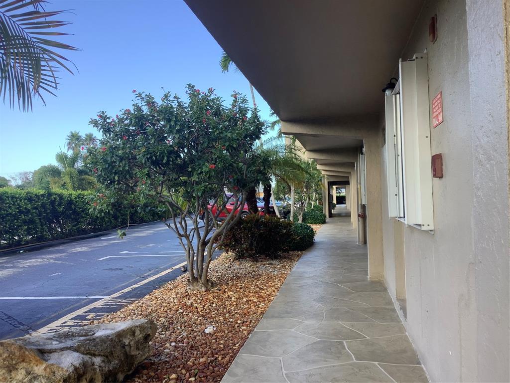 2300 Northeast 1st Lane, Unit 107 Boynton Beach, FL 33435 - Photo 25 of 26 a view of a path along with potted plants
