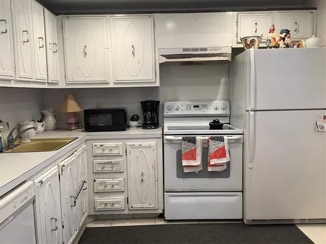 a kitchen with appliances and cabinets
