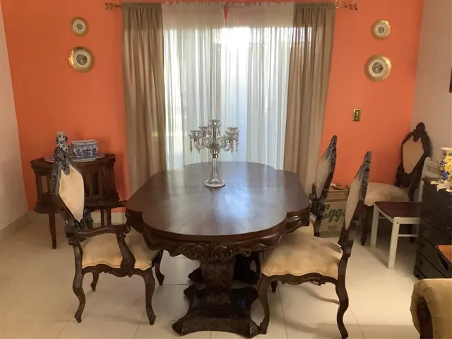 a dining room with furniture and window