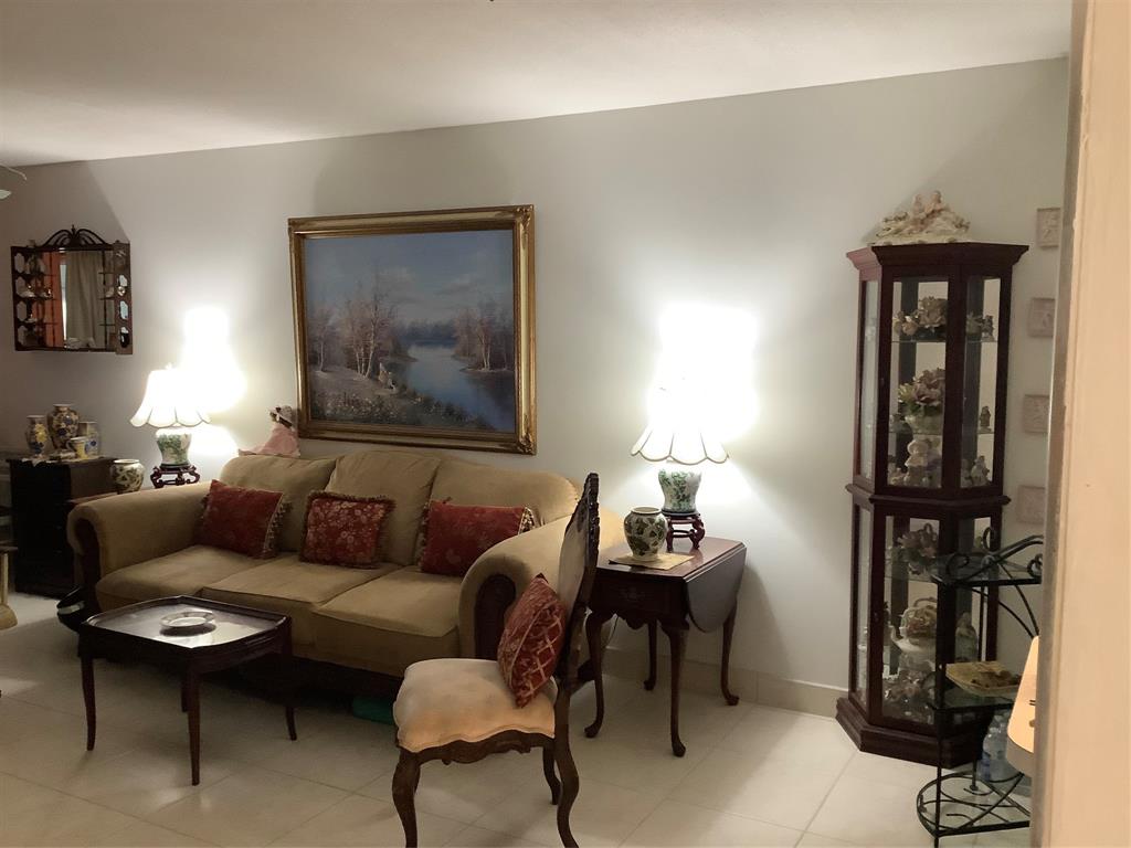 2300 Northeast 1st Lane, Unit 107 Boynton Beach, FL 33435 - Photo 9 of 26 a living room with furniture and a window