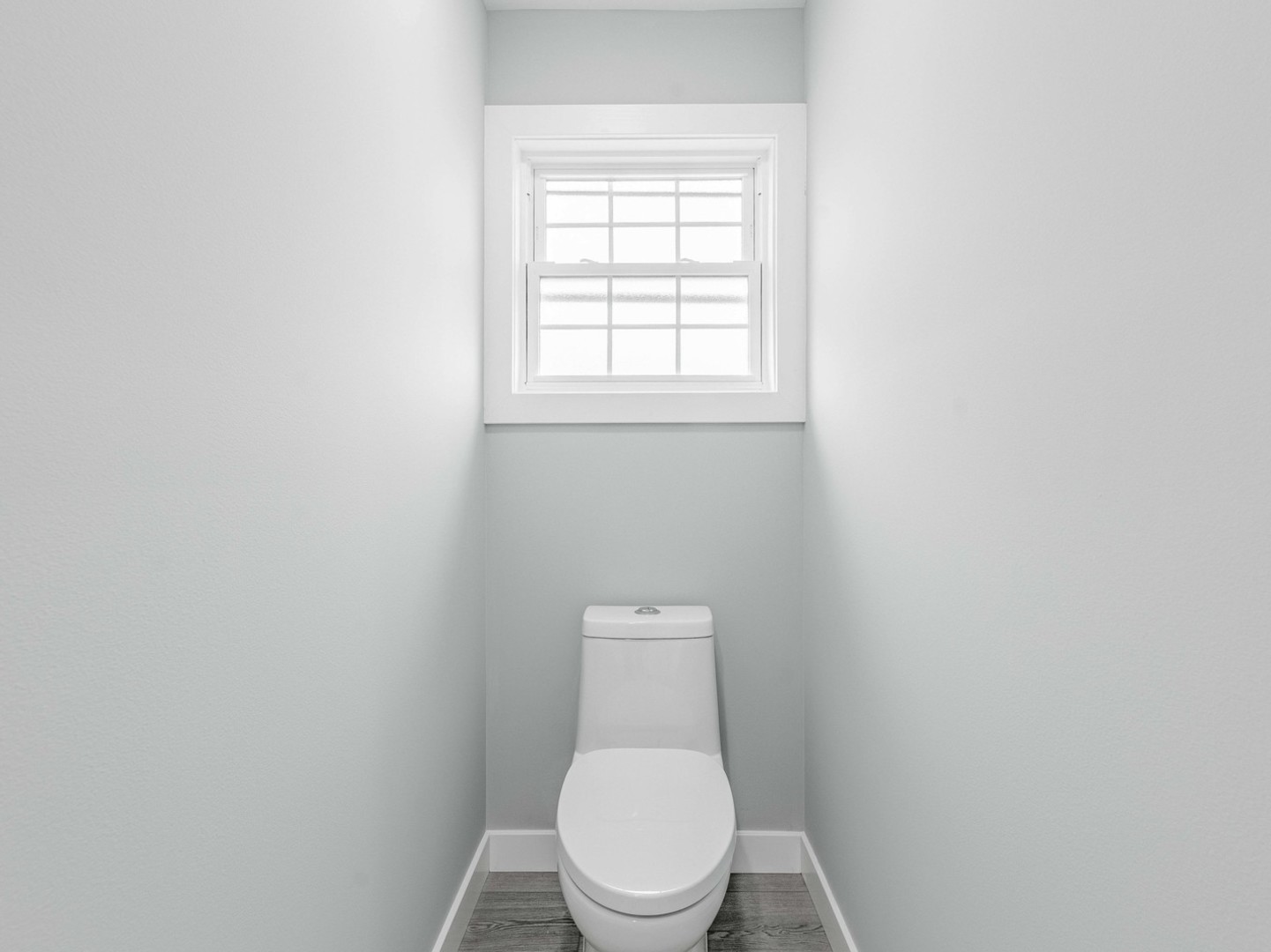 3548 Clinton Avenue Berwyn, IL 60402 - Photo 14 of 49 a white toilet sitting in a bathroom next to a window