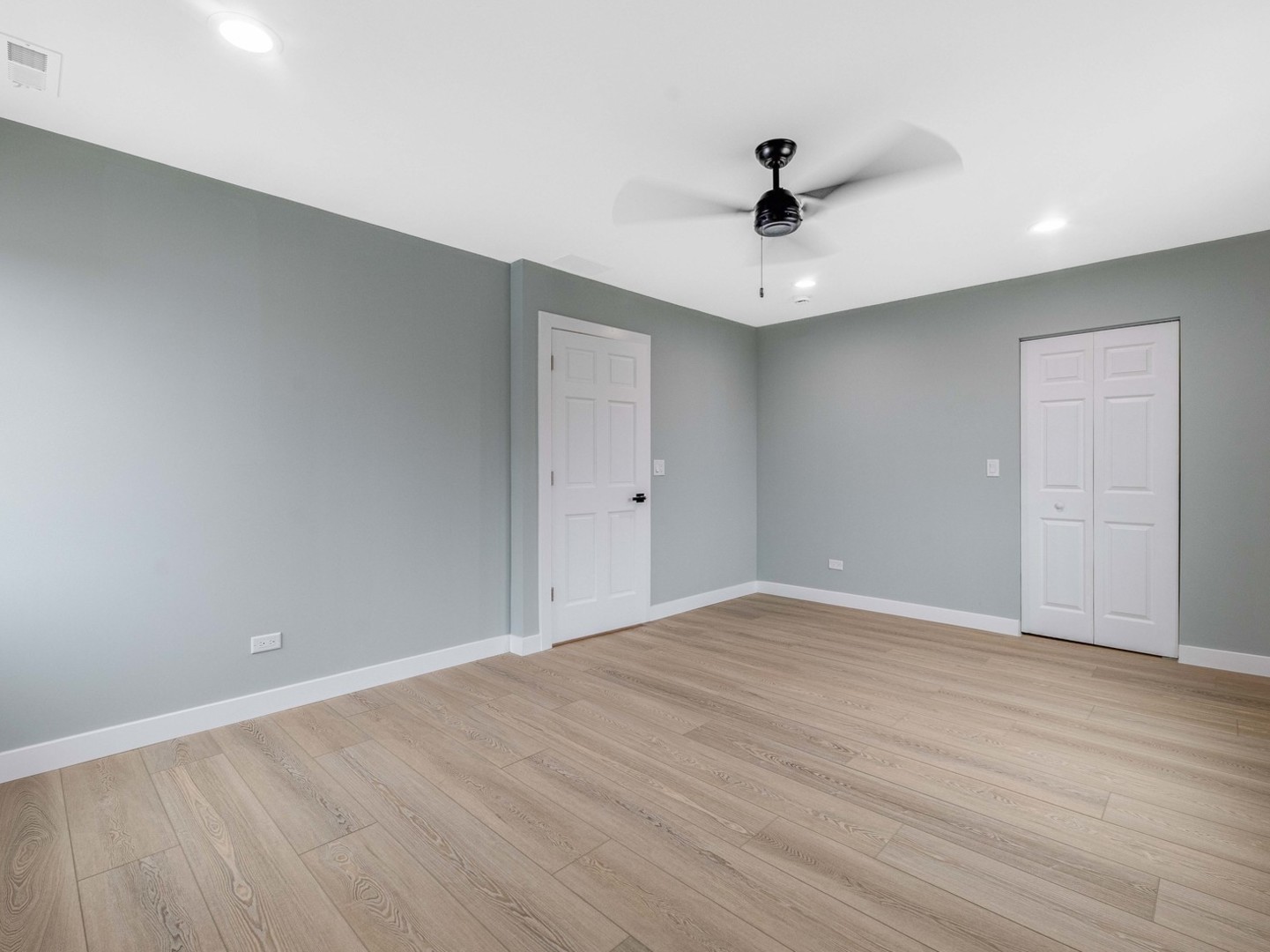 3548 Clinton Avenue Berwyn, IL 60402 - Photo 21 of 49 a view of an empty room with wooden floor and a ceiling fan