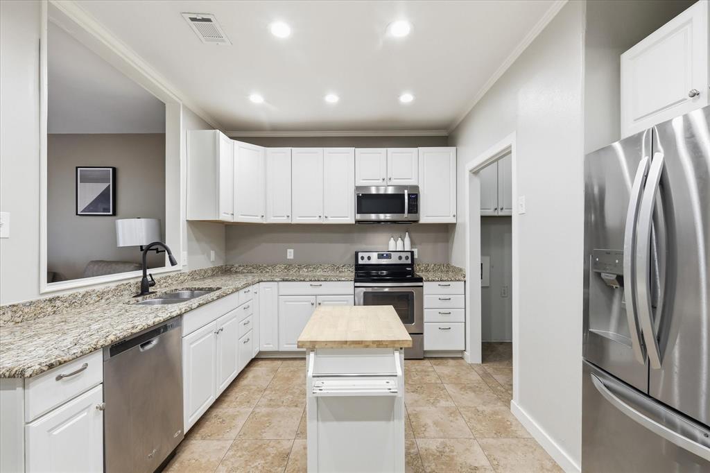 14277 Preston Road, Unit 615 Dallas, TX 75254 - Photo 10 of 20 a large kitchen with stainless steel appliances granite countertop a refrigerator sink and stove