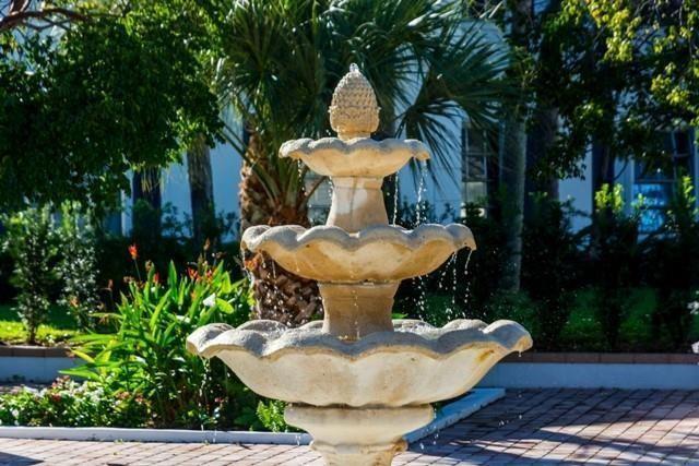 2171 Northeast 66th Street, Unit 830 Fort Lauderdale, FL 33308 - Photo 12 of 24 a view of a fountain in the backyard of house along with trees