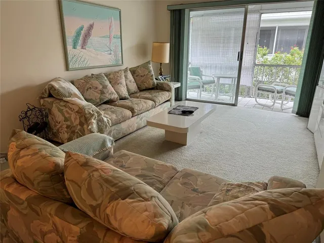 a living room with a couch and a large window