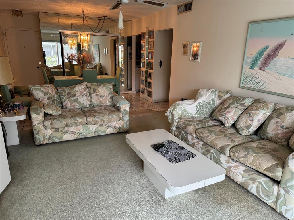 2171 Northeast 66th Street, Unit 830 Fort Lauderdale, FL 33308 - Photo 4 of 24 a living room with furniture and a window