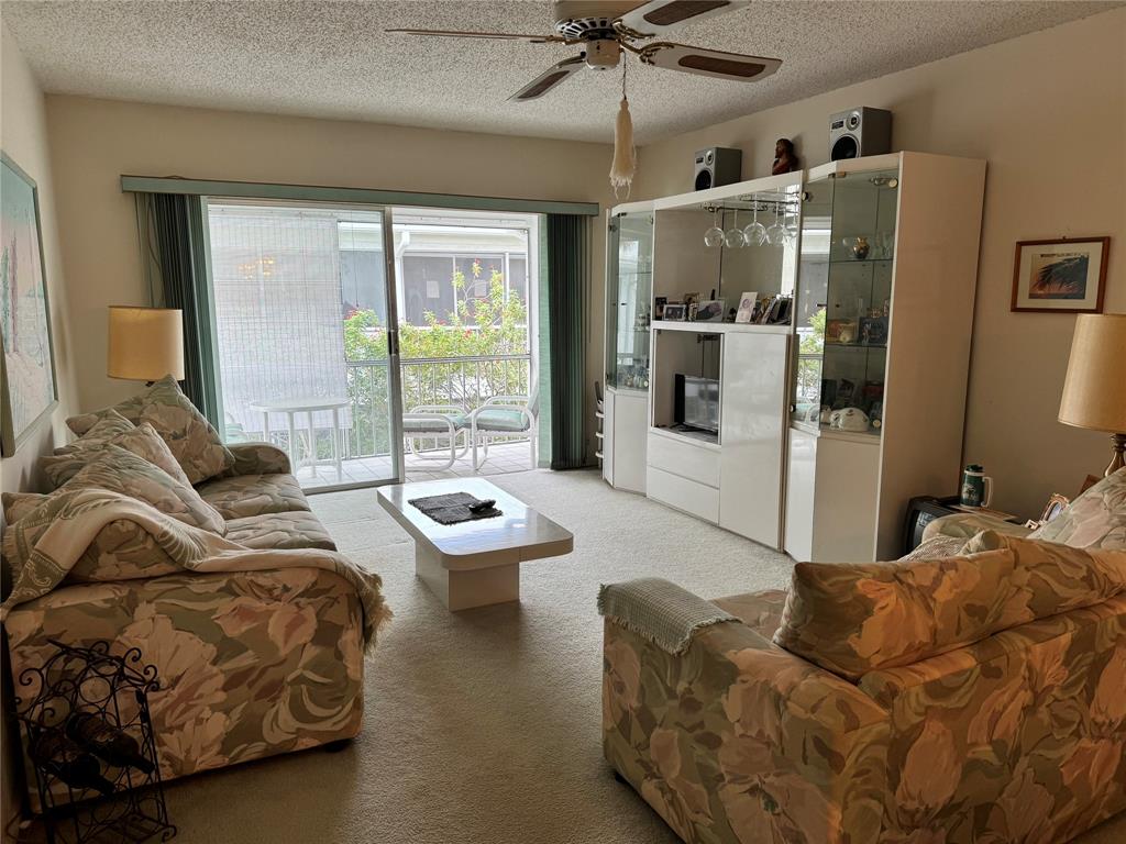 2171 Northeast 66th Street, Unit 830 Fort Lauderdale, FL 33308 - Photo 5 of 24 a living room with furniture and a large window