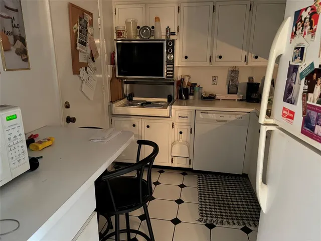 a kitchen with a sink appliances and cabinets