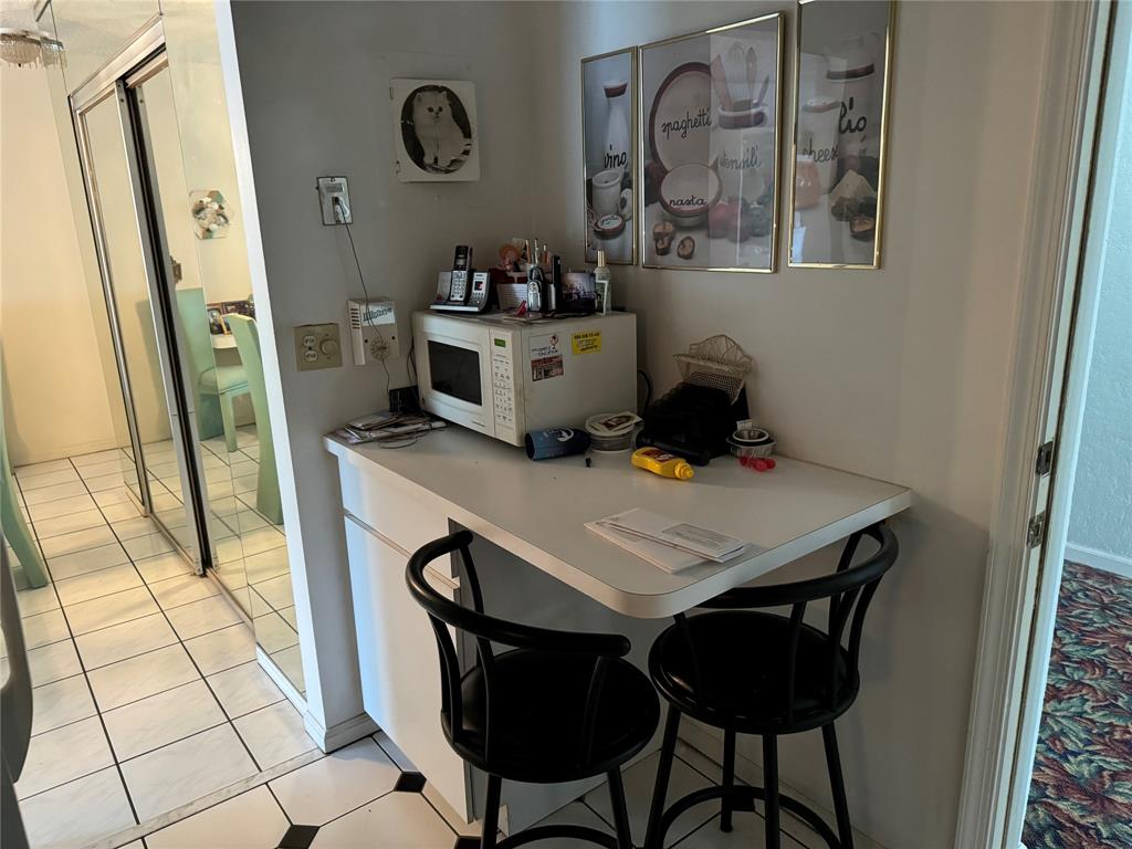 2171 Northeast 66th Street, Unit 830 Fort Lauderdale, FL 33308 - Photo 9 of 24 a view of a dining room with furniture and wooden floor