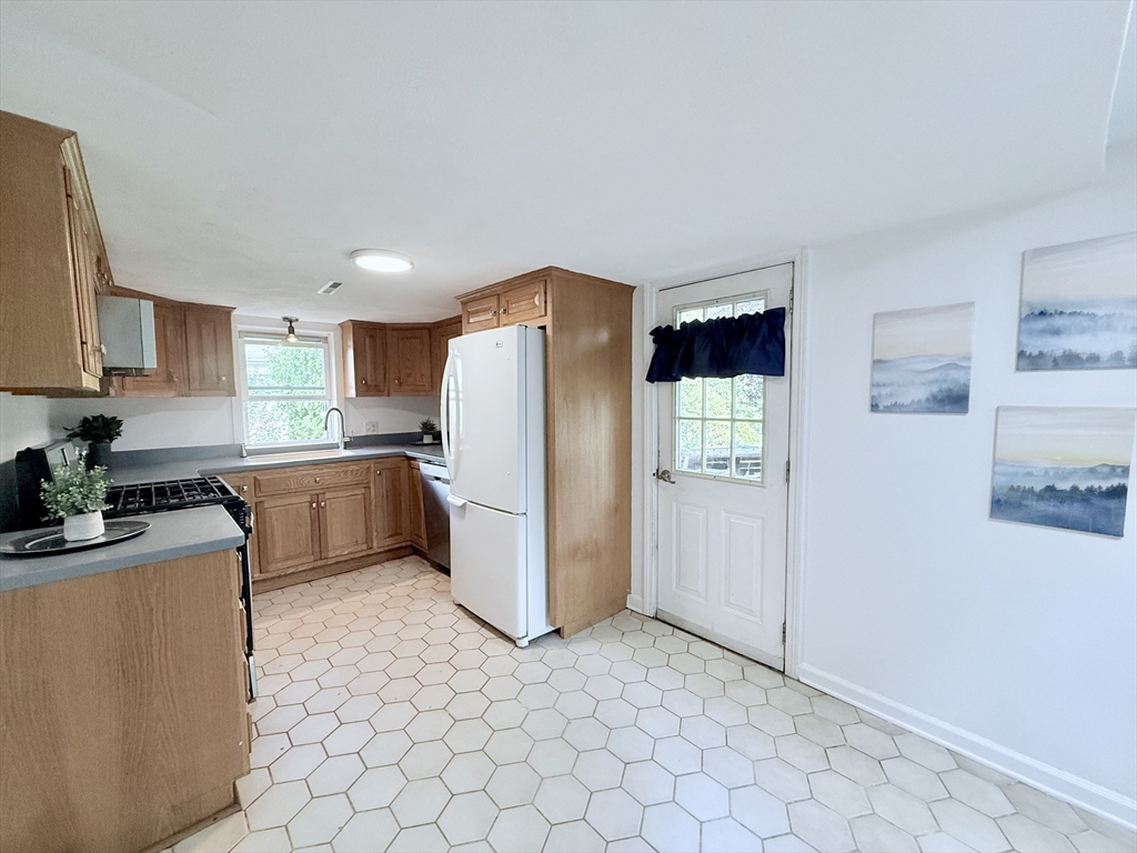975 South Main Street Bellingham, MA 02019 - Photo 20 of 38 a kitchen with a refrigerator sink and cabinets