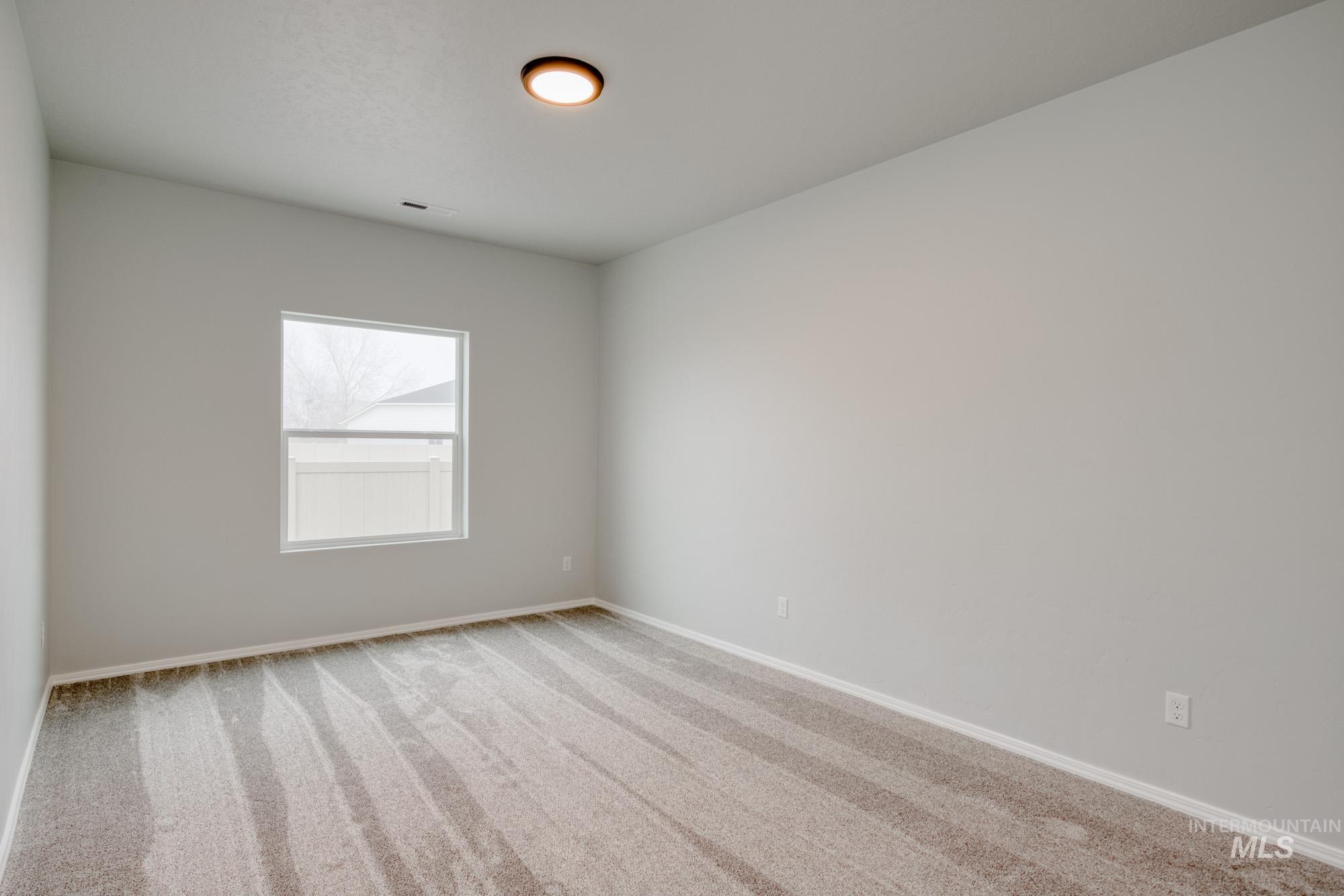 1672 Dyer Street Middleton, ID 83644 - Photo 16 of 24 Carpeted spare room featuring baseboards