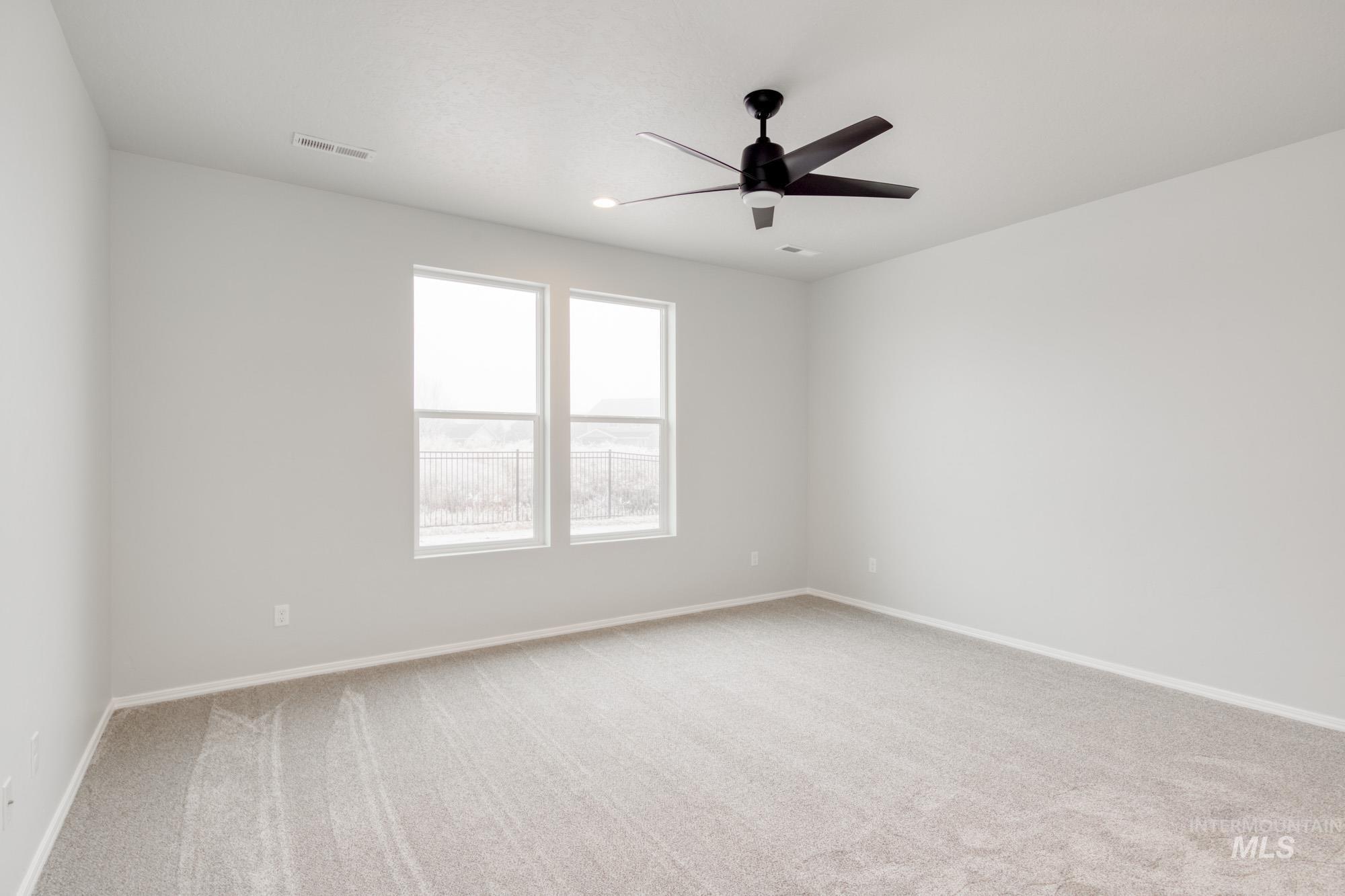 1672 Dyer Street Middleton, ID 83644 - Photo 17 of 24 Empty room with light colored carpet, ceiling fan, and recessed lighting