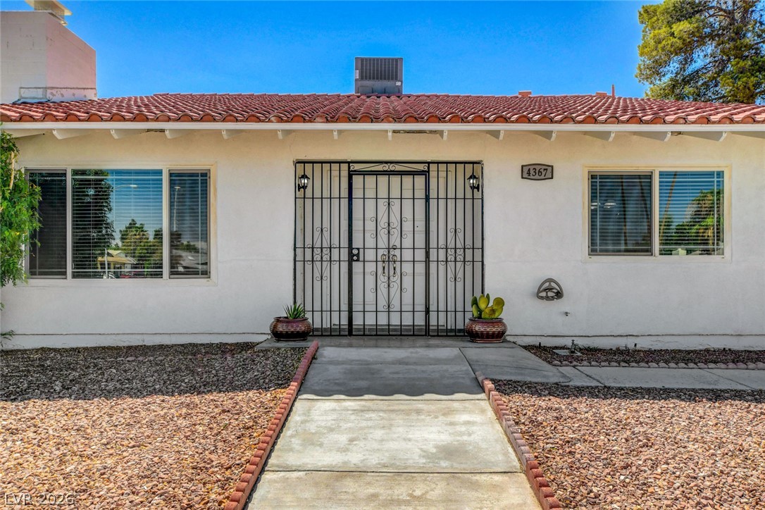 4367 South Mojave Road Las Vegas, NV 89121 - Photo 4 of 53 A terracotta tile roof crowns this residence, featuring security bars on windows and main entry.
