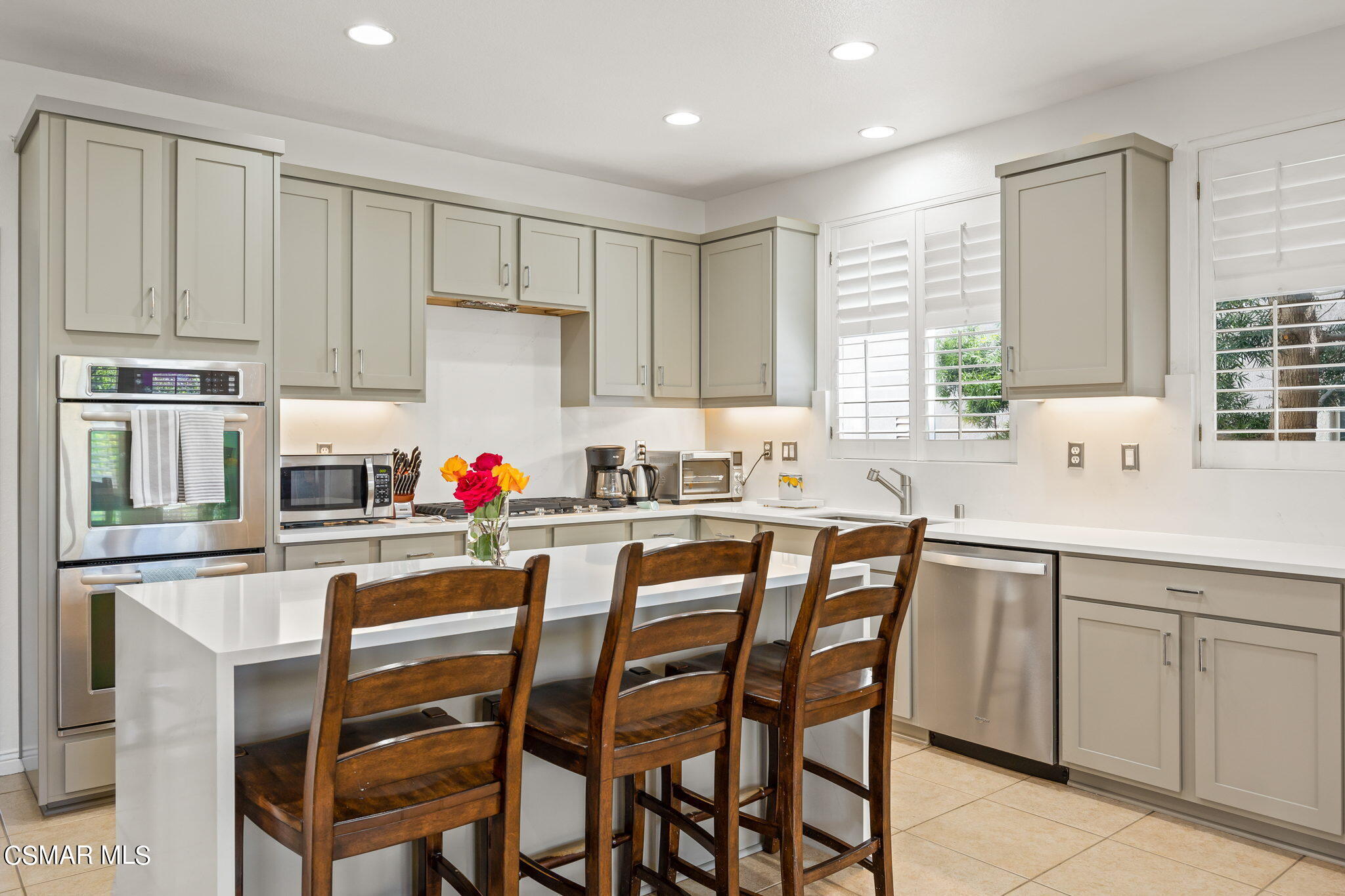 388 Woodland Road Simi Valley, CA 93065 - Photo 18 of 62 a kitchen with white cabinets and stainless steel appliances