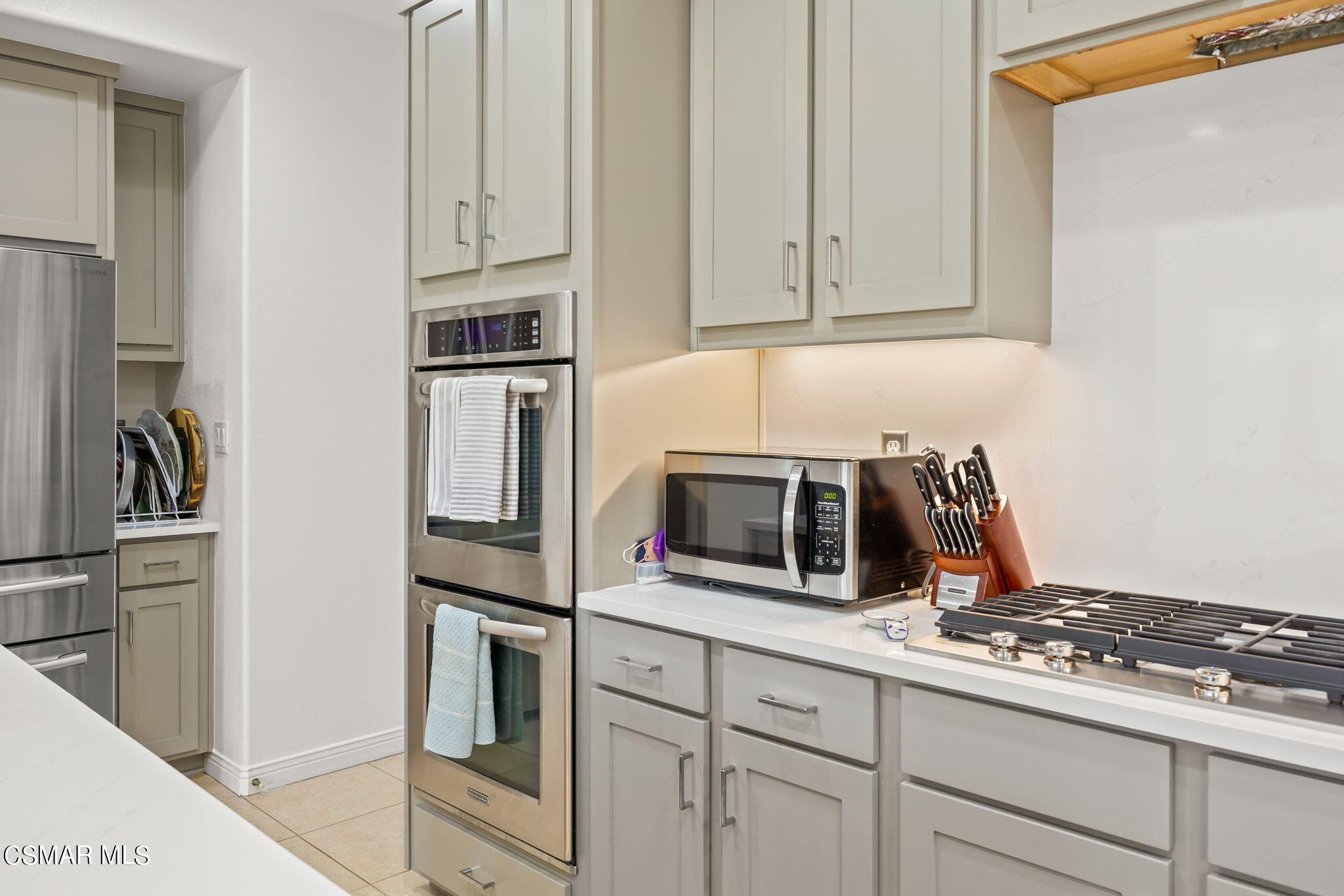 388 Woodland Road Simi Valley, CA 93065 - Photo 22 of 62 a kitchen with stainless steel appliances granite countertop white cabinets and a stove