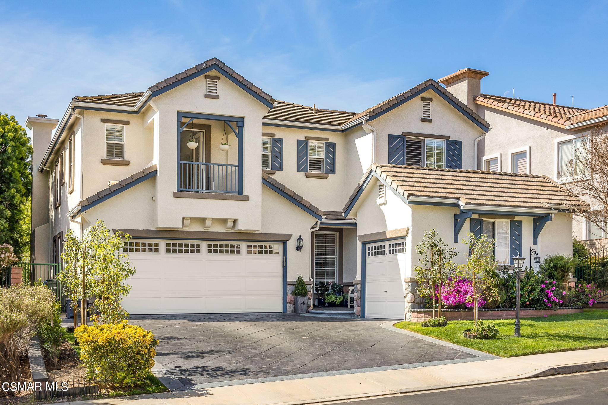 388 Woodland Road Simi Valley, CA 93065 - Photo 3 of 62 a front view of a house with a yard and garage