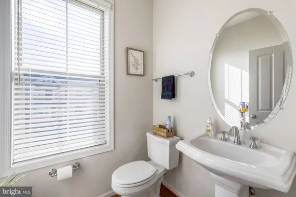 a bathroom with a toilet a sink and a mirror