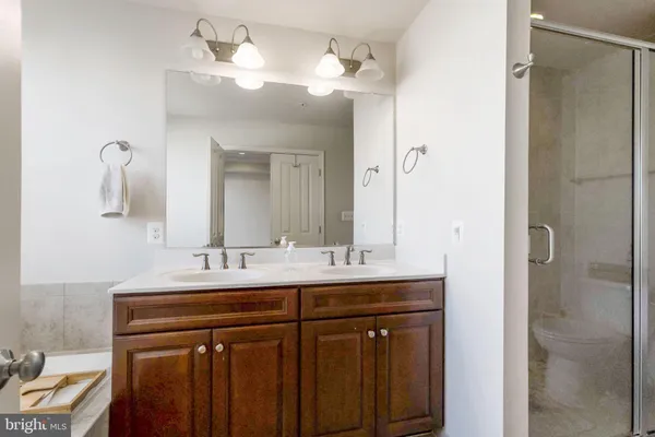 a bathroom with a double vanity sink and a mirror