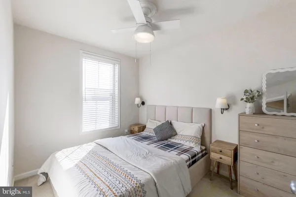 a bedroom with a bed and a dresser