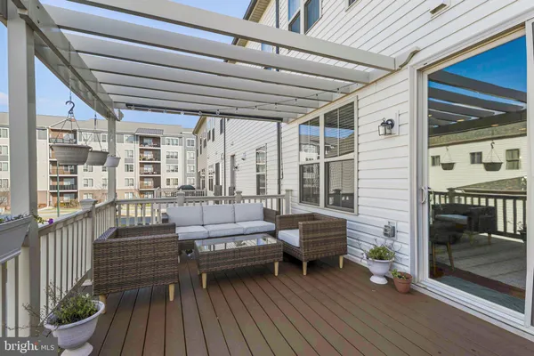 a balcony with furniture and a potted plant