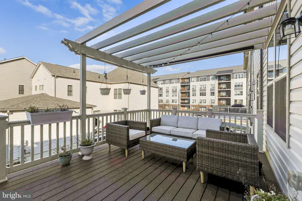 a balcony with furniture and wooden floor