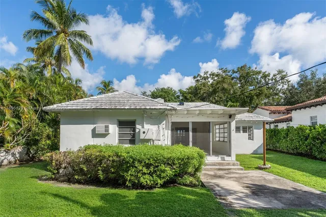 a front view of a house with a garden