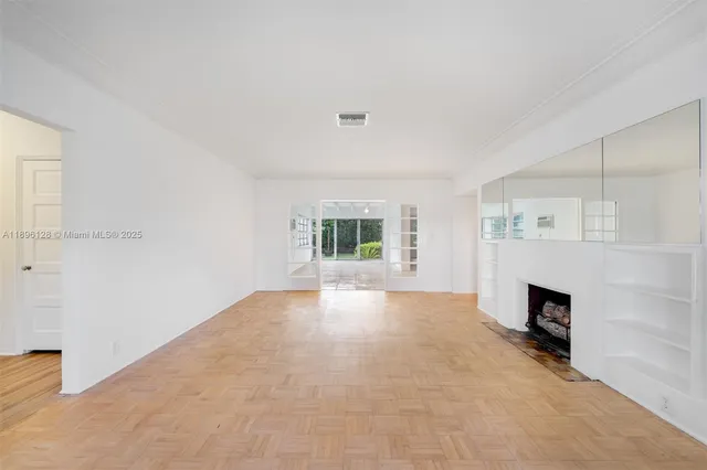 a view of an empty room with a fireplace