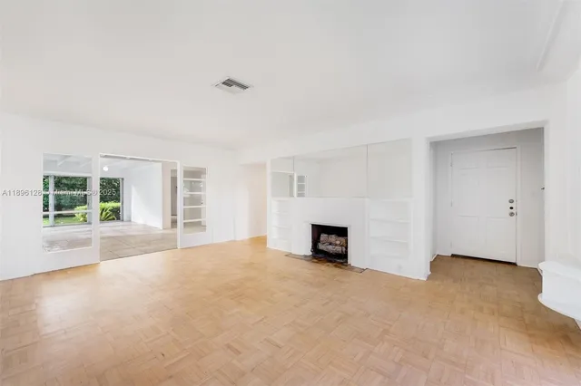 a view of empty room with a fireplace