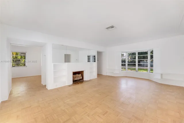 an empty room with furniture and fireplace